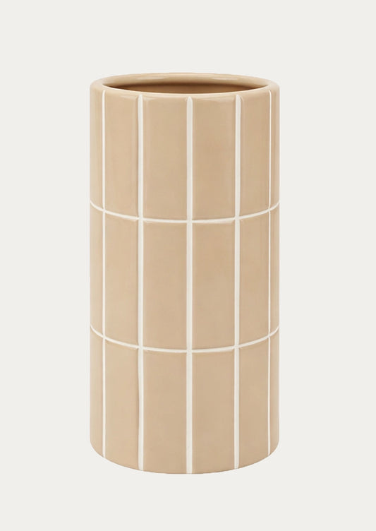 A tall, cylindrical ceramic vase in a warm beige color, decorated with a white grid pattern.