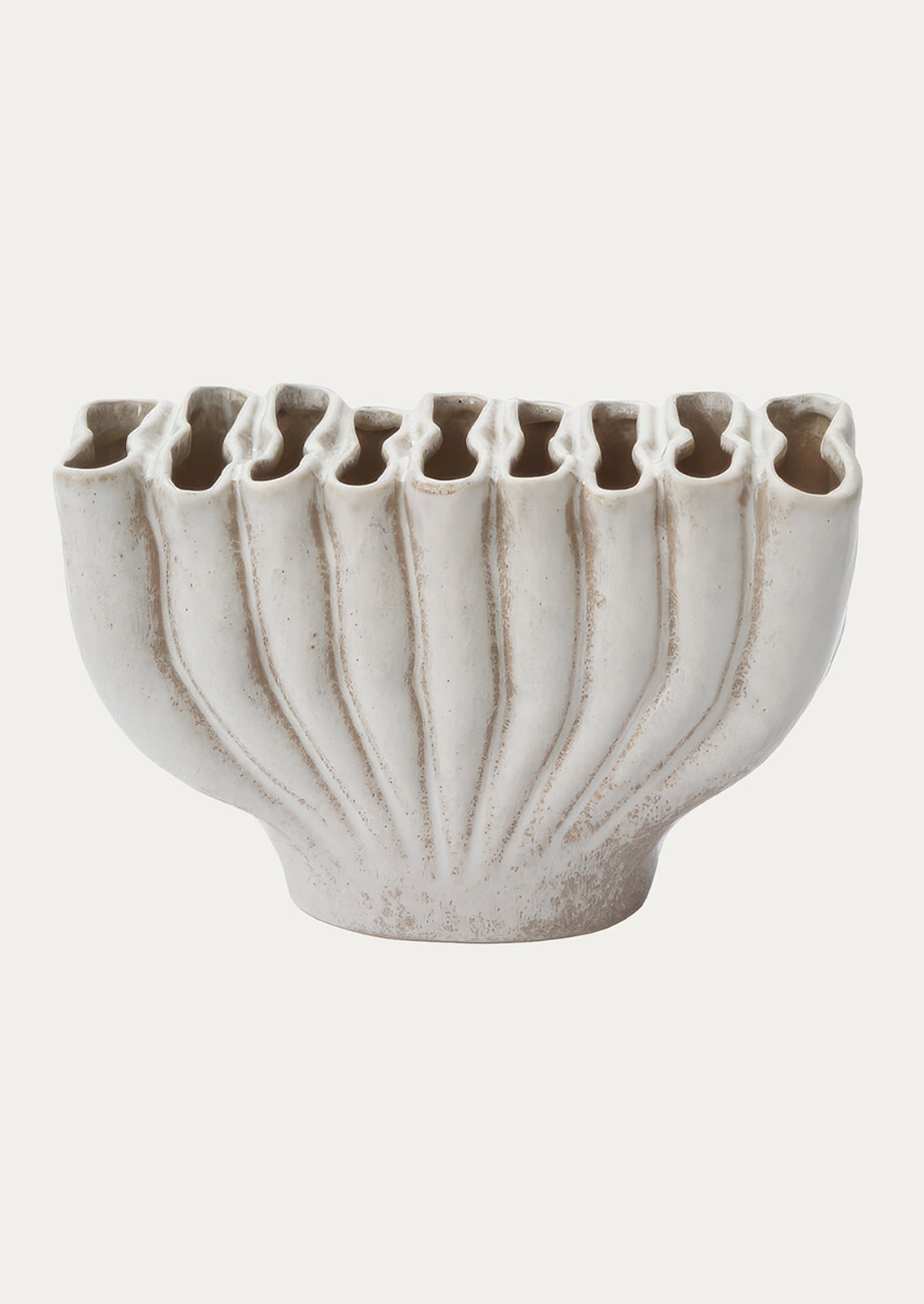 A fluted ceramic vase with east-west orientation and slot-like openings at top.