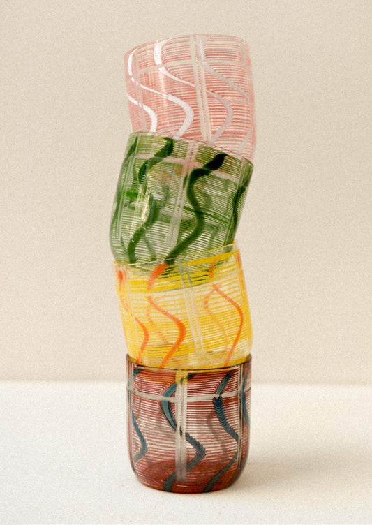 Colorful glass drinking glasses with a wave design.