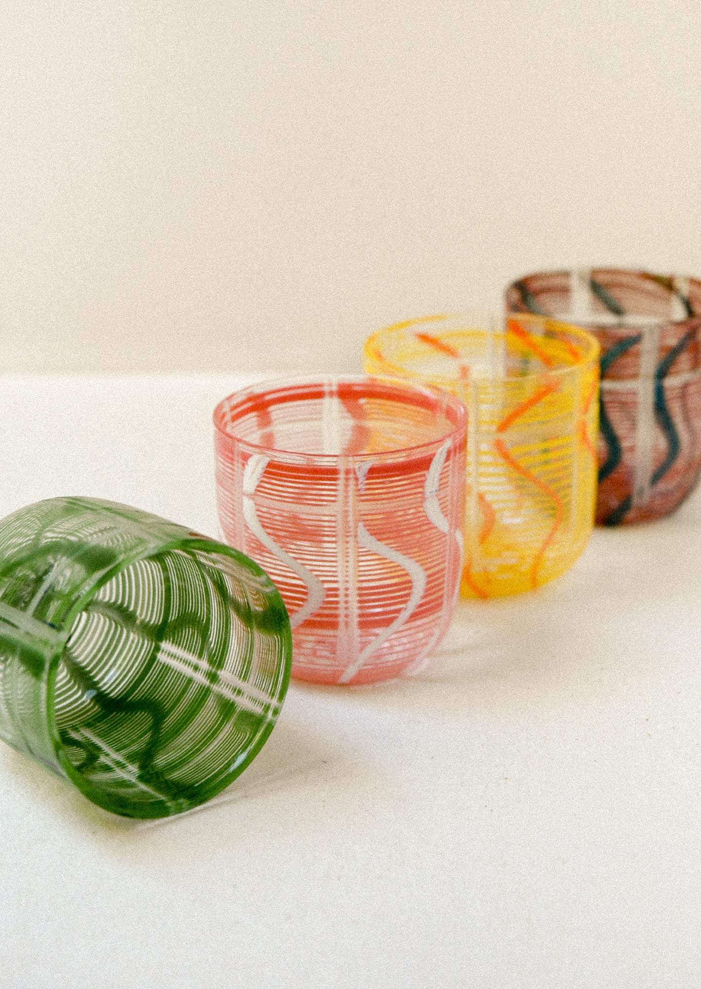 Colorful glass drinking glasses with a wave design.