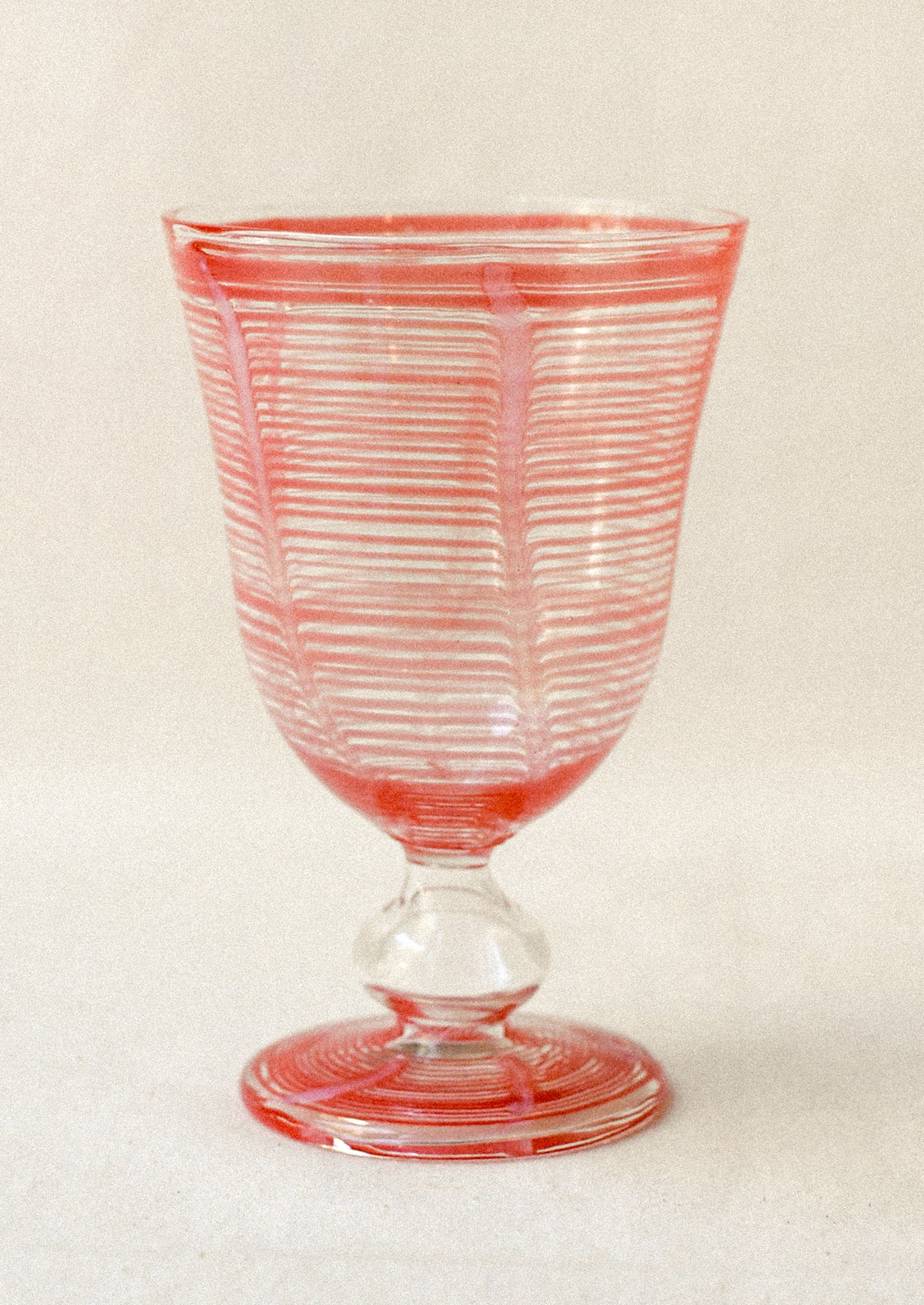 Clear glass with pink stripes on a white background