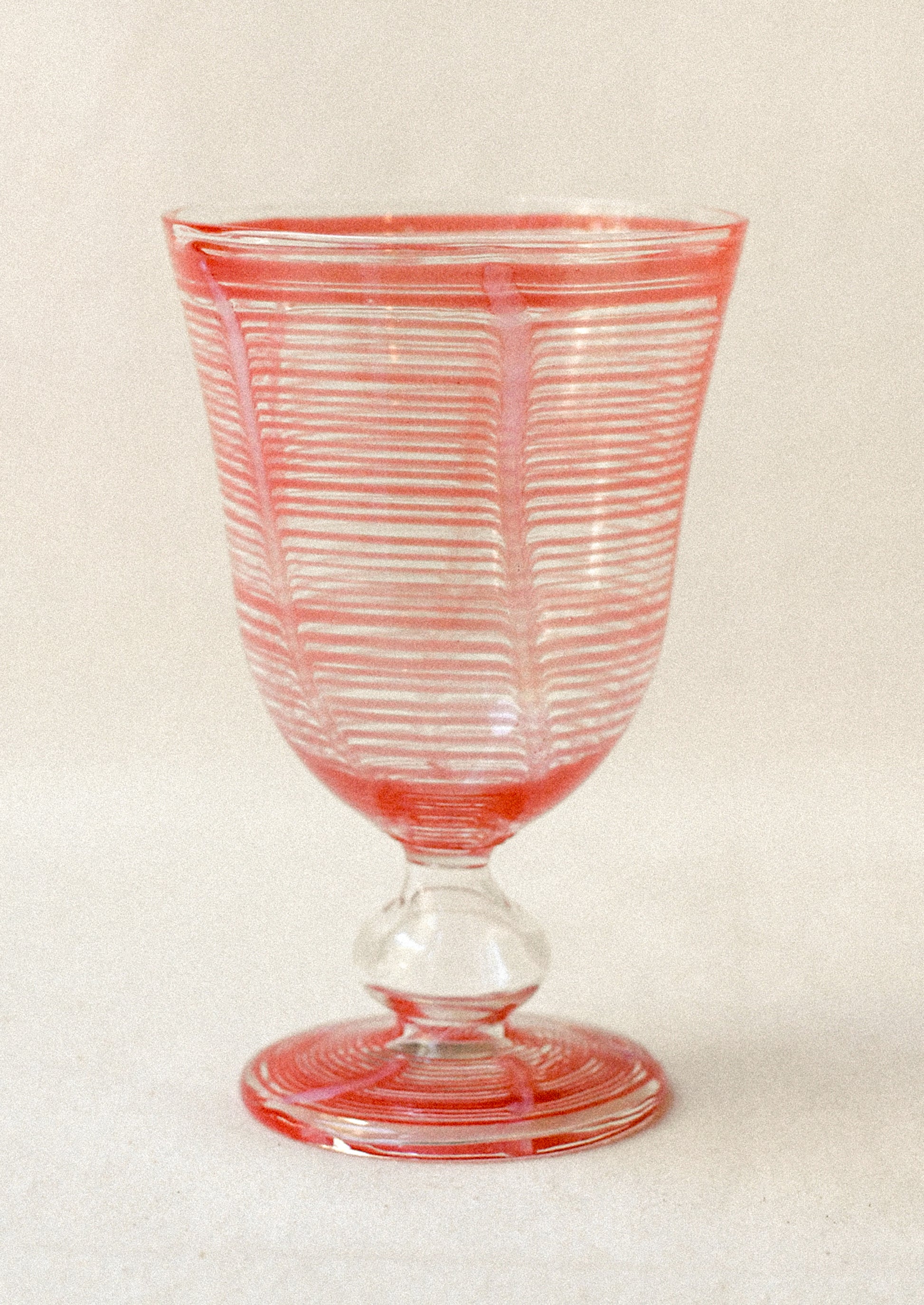 Clear glass with pink stripes on a white background