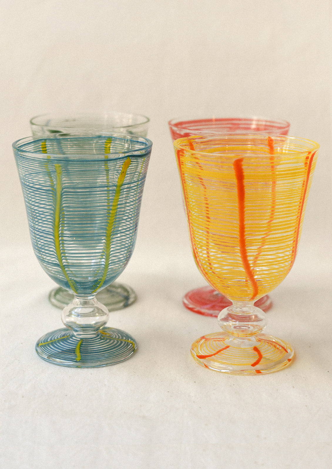 Colorful glass goblets on a white background