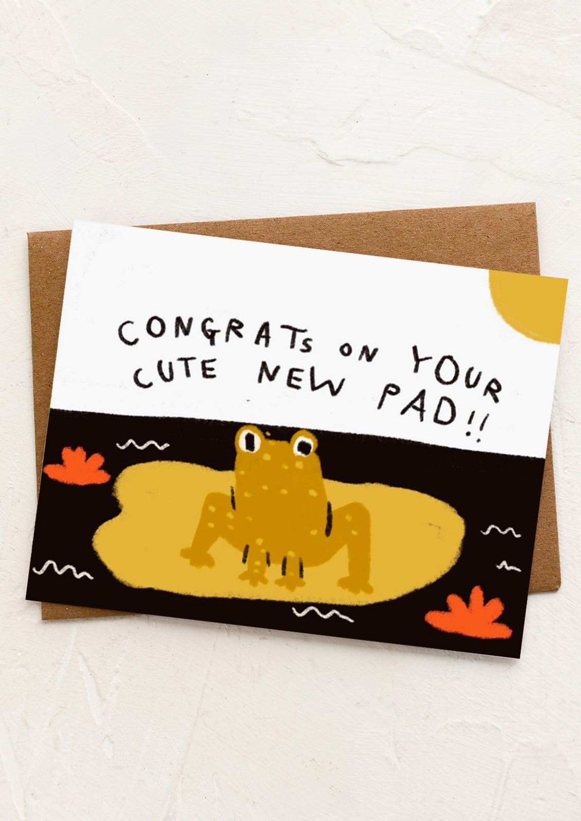 A card with image of frog on lily pad reading "Congrats on your cute new pad!!".