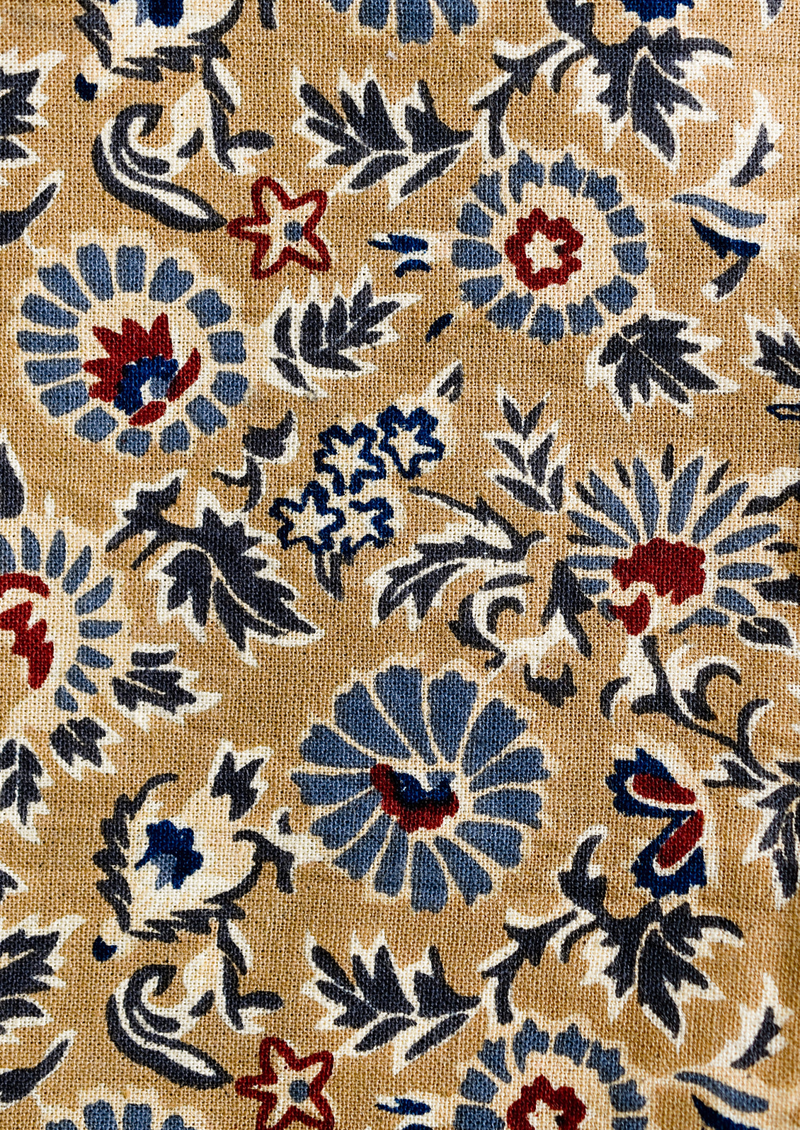 A floral print napkin set in brown, indigo and red.