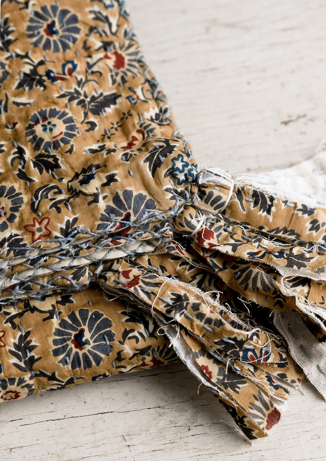 Tassel trim detailing on cotton throw.