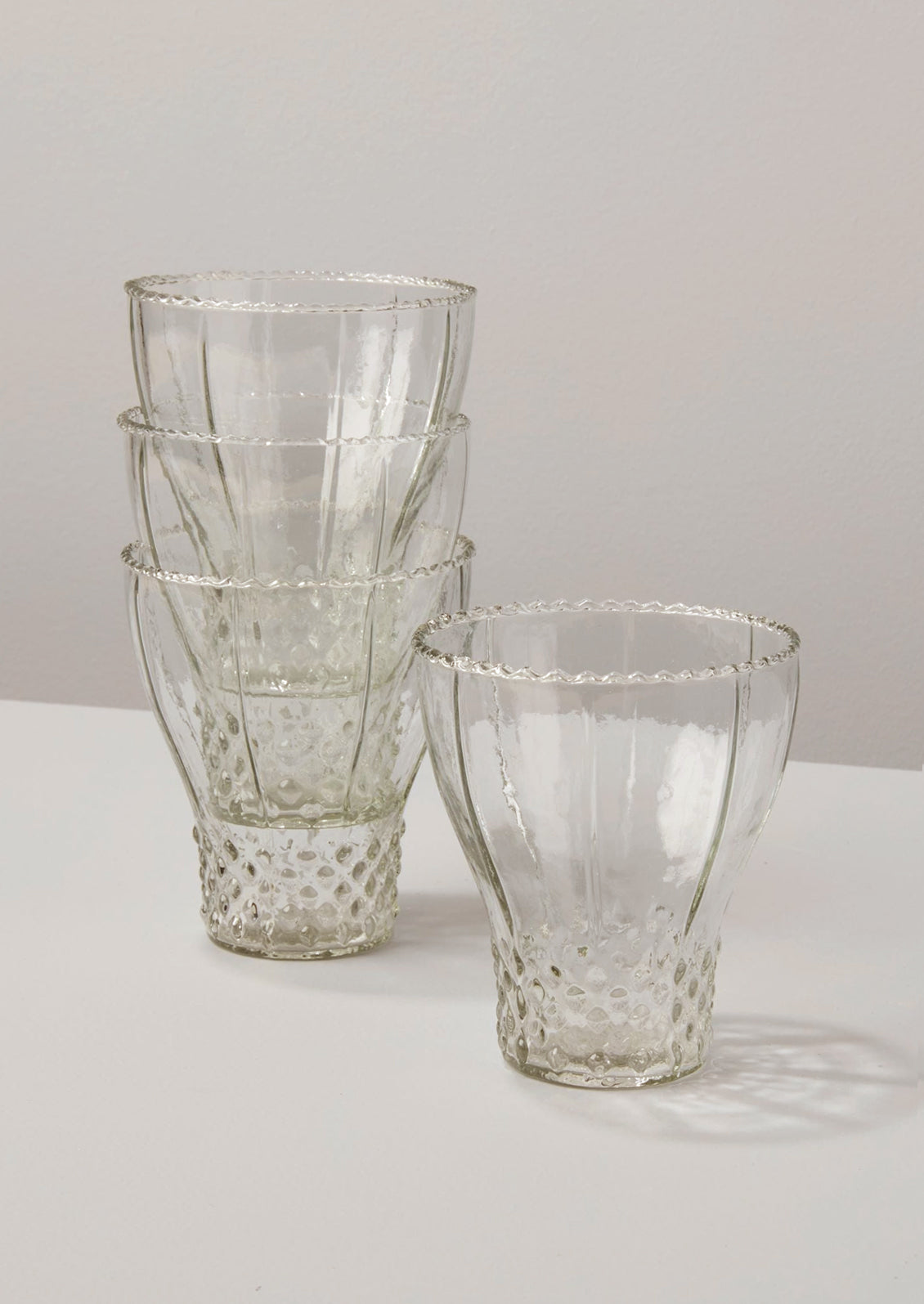 Glasses in bell shape with hobnail pattern.