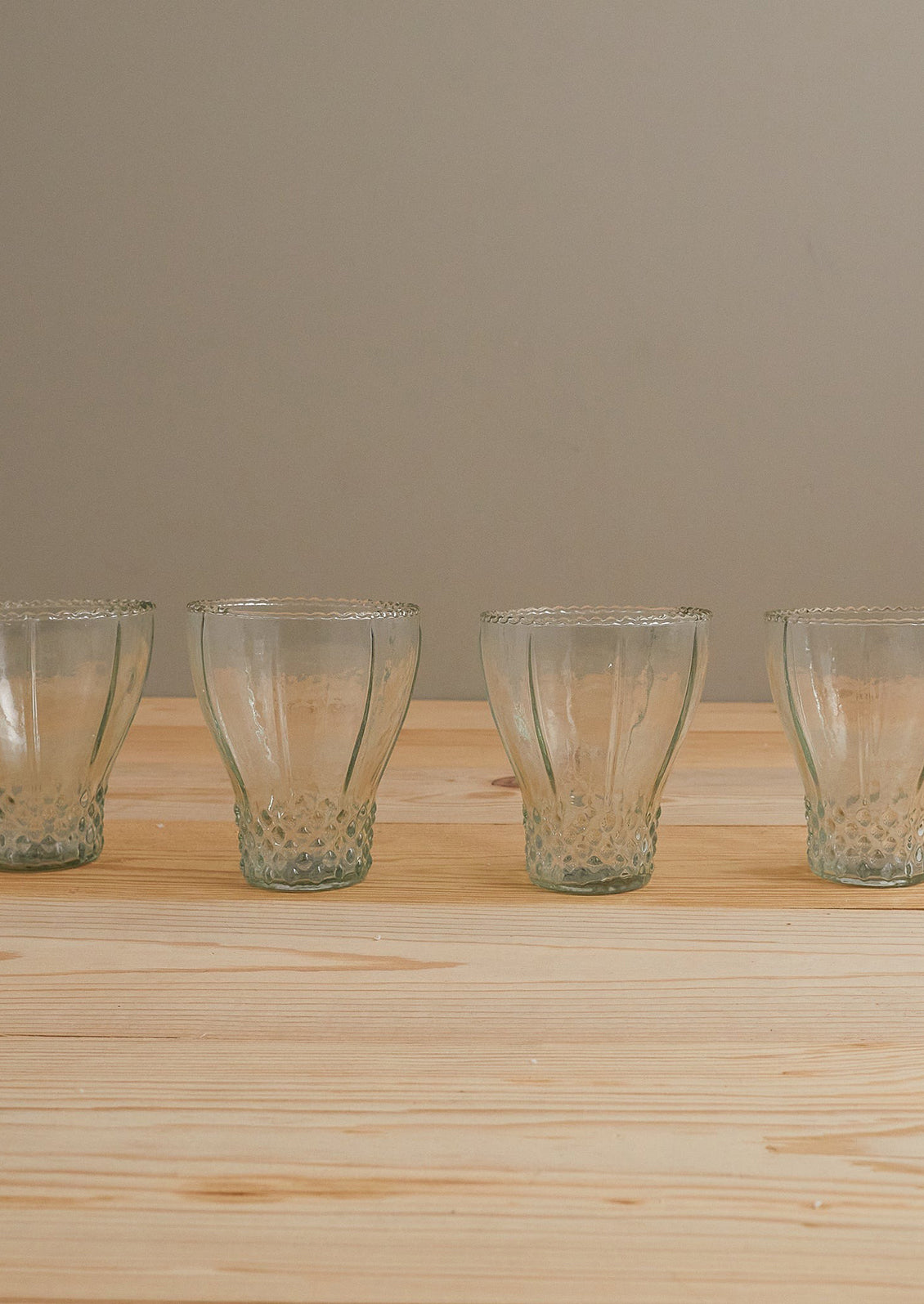 Glasses in bell shape with hobnail detailing.