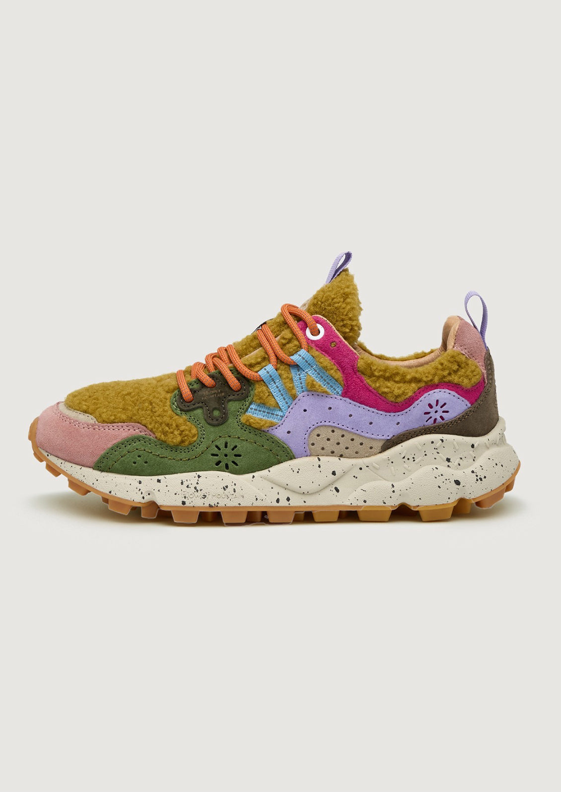 A pair of sporty sneakers in bright multicolor with ochre shearling upper.