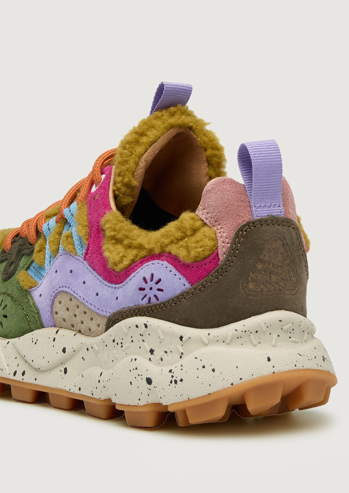 A pair of sporty sneakers in bright multicolor with ochre shearling upper.