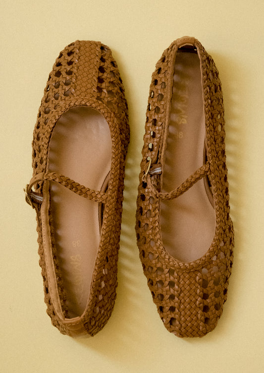 A pair of brown open weave ballet flats.