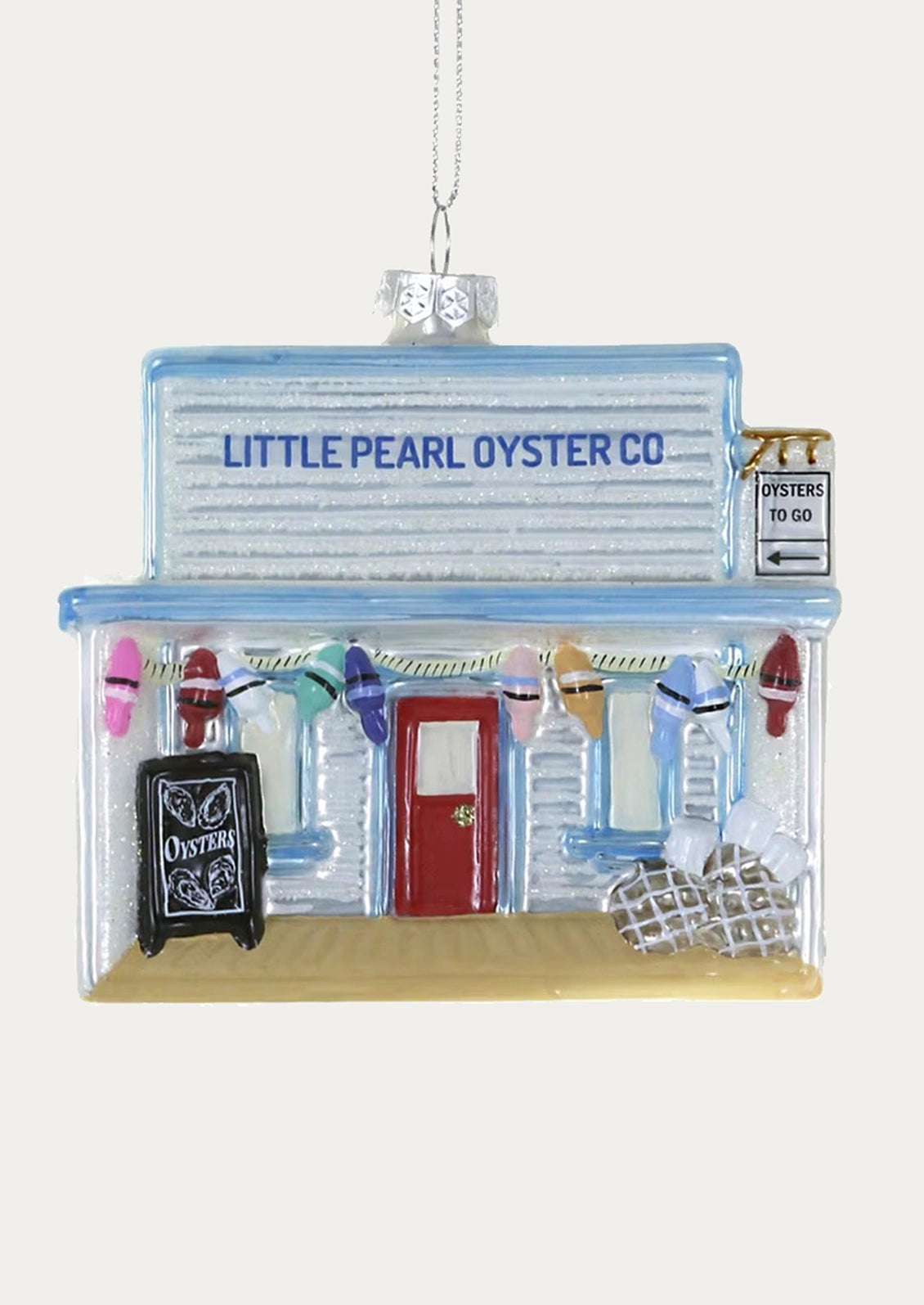A glass ornament depicting an oyster shack.