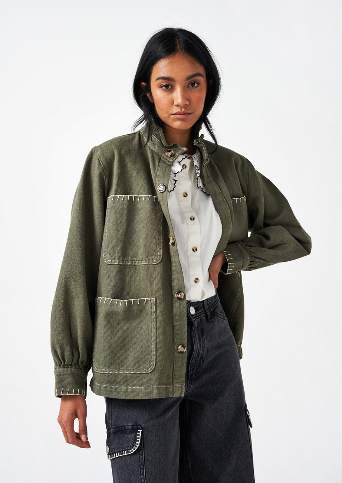 Woman wearing a khaki green cotton jacket.