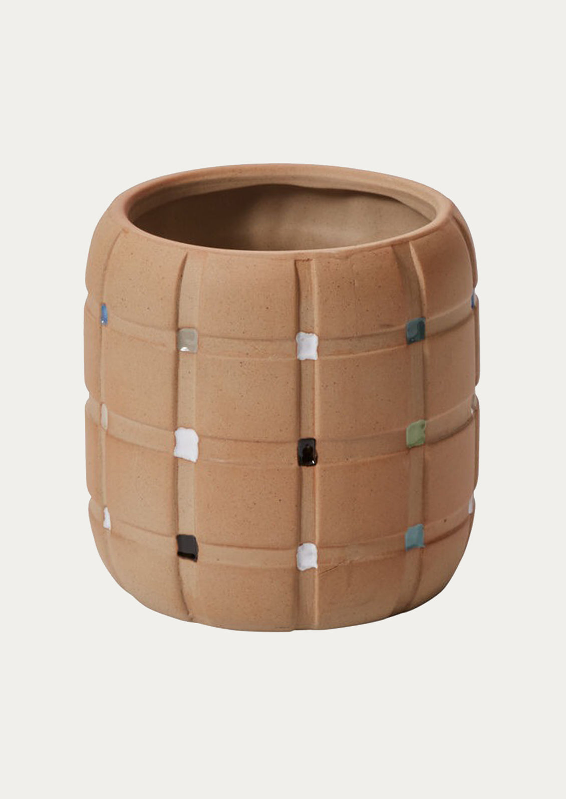 A sand ceramic planter with grid pattern and painted swatches at intersections.