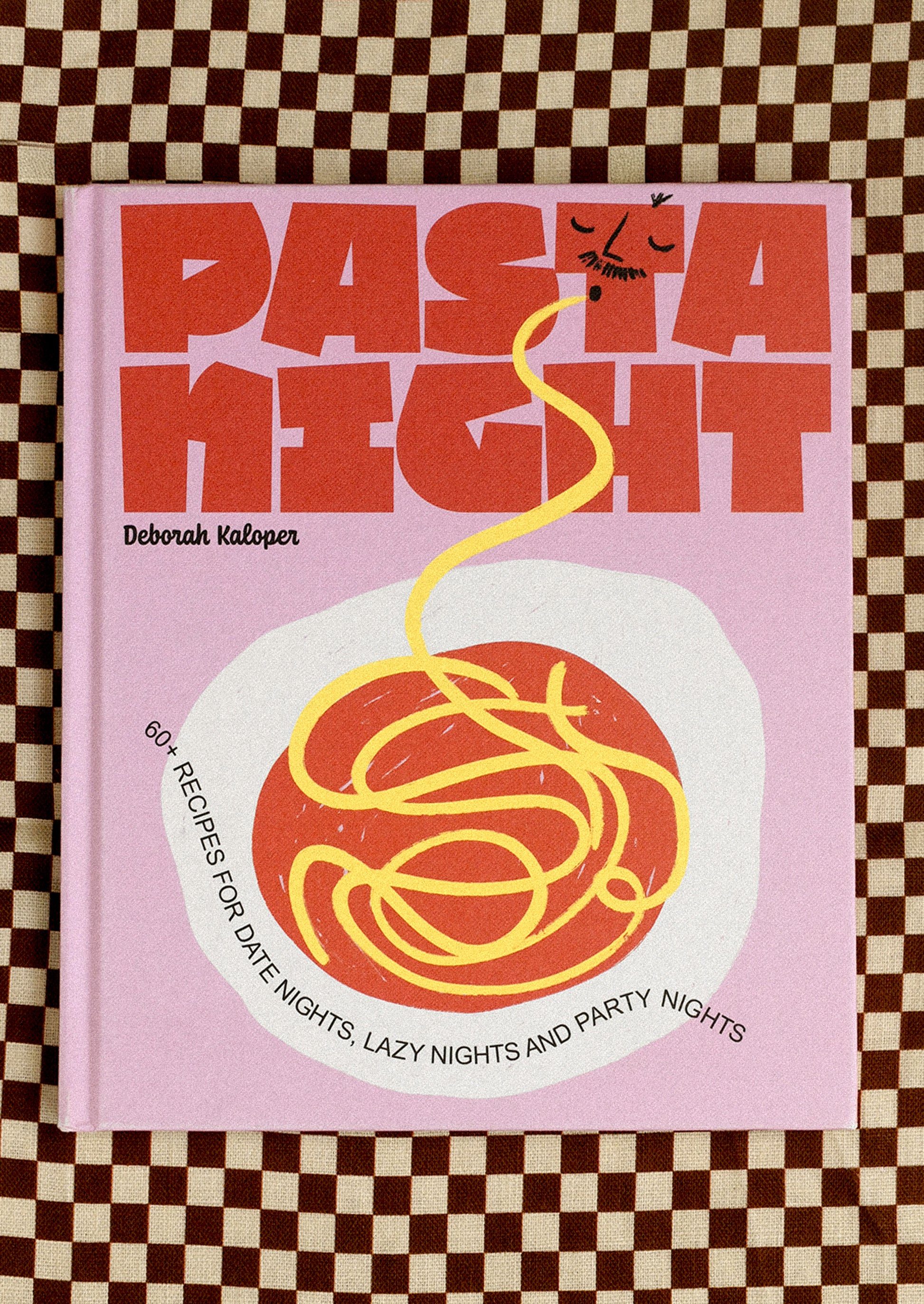 Book titled 'Pasta Night' on a checkered background
