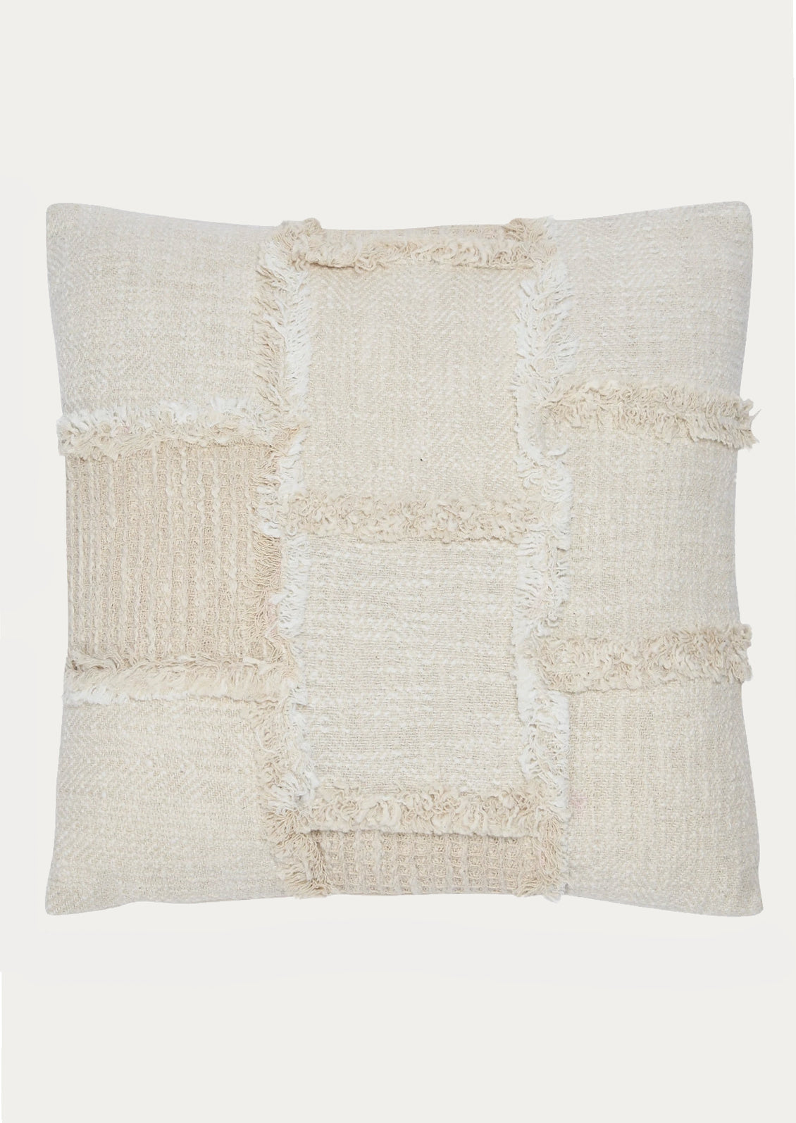 A throw pillow in natural cotton with patchwork detailing in different textures.