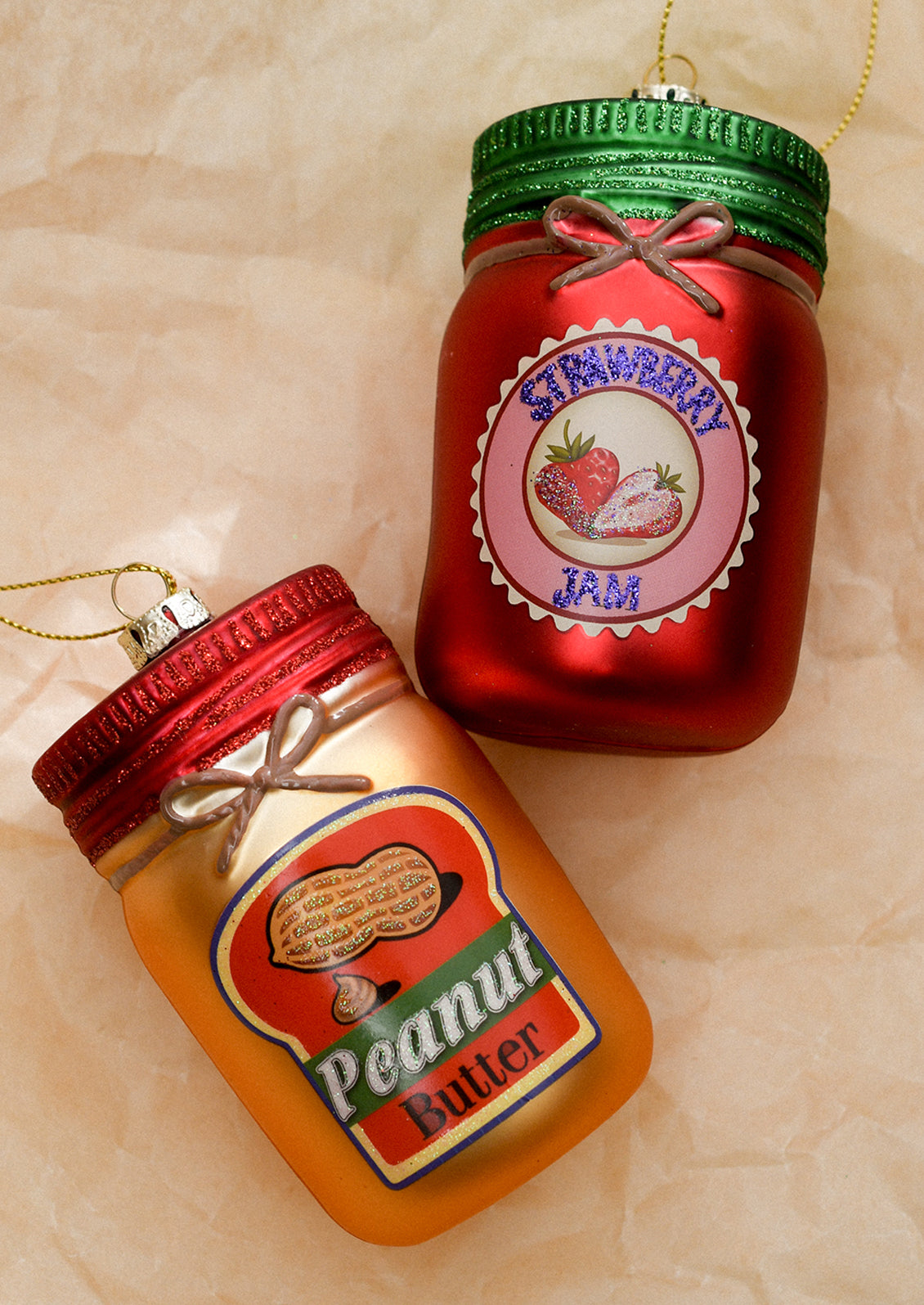 Glass ornaments resembling jars of peanut butter and strawberry jam.