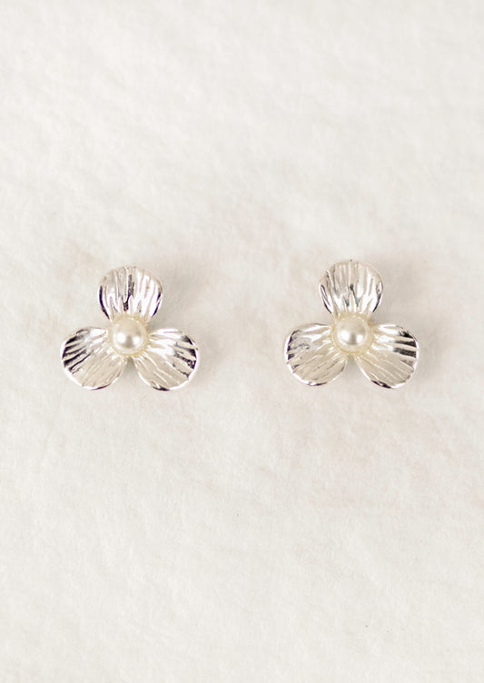 A pair of sterling silver 3-petal flower studs with a pearl center.
