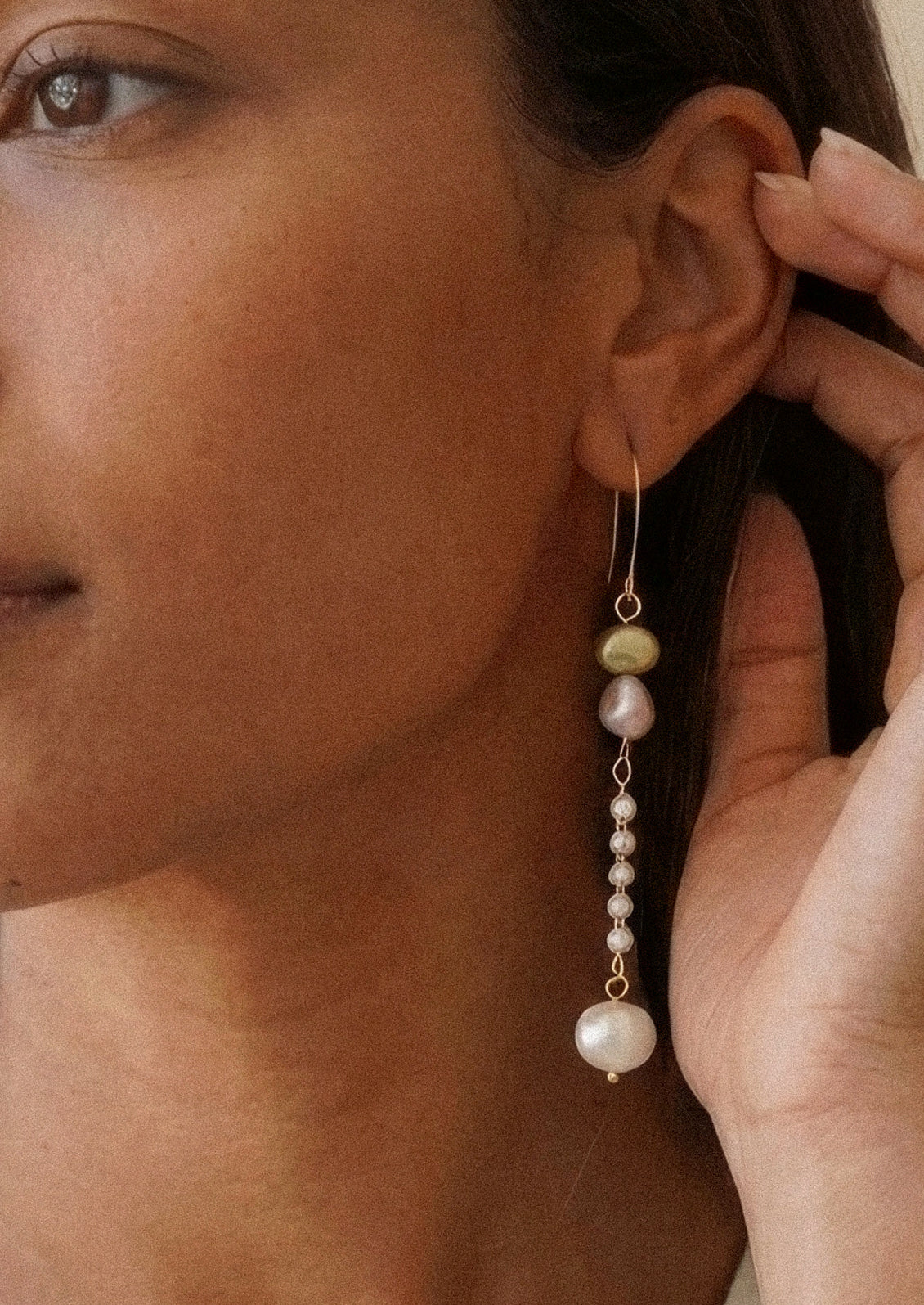 A pair of dangling earrings with freshwater pearls and faux pearls.