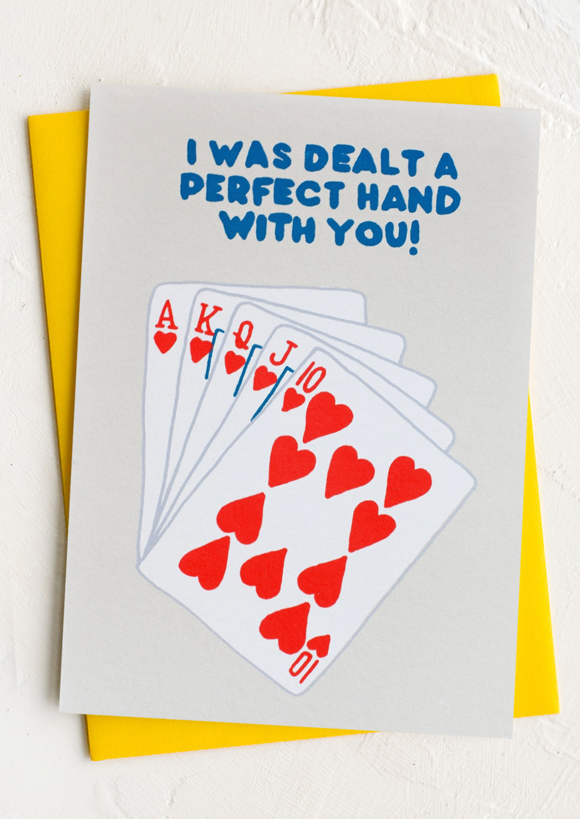 A greeting card with image of playing cards, text reads "I was dealt a perfect hand with you!".