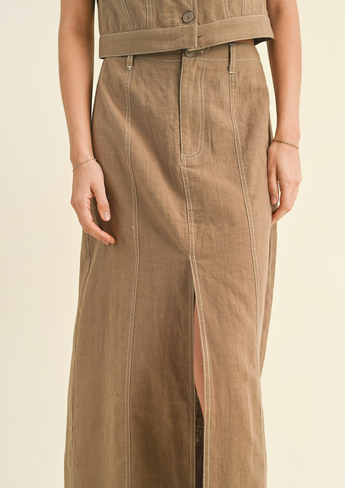 Woman wearing tan cotton midi skirt.