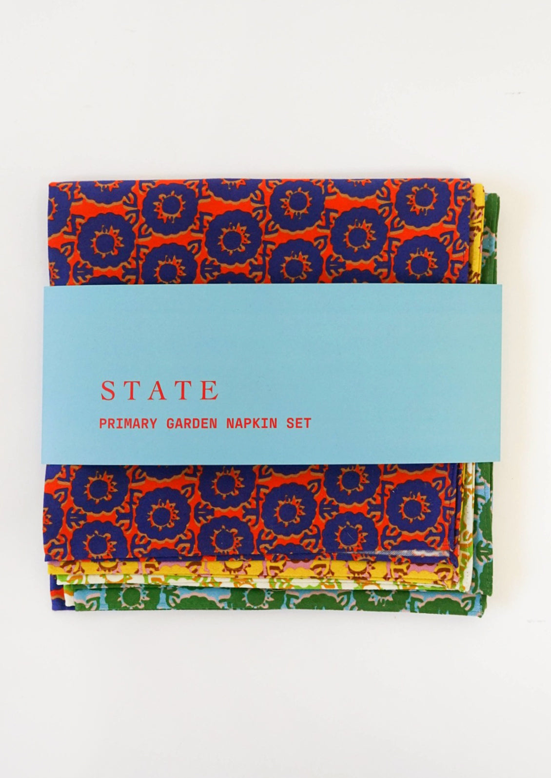 A set of four different brightly colored napkins in floral pattern.