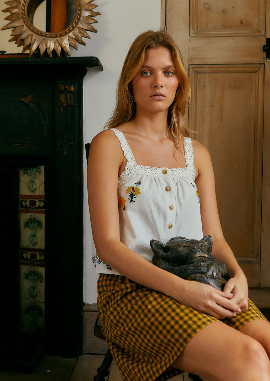 A white cotton shirt with multicolor floral embroidery.