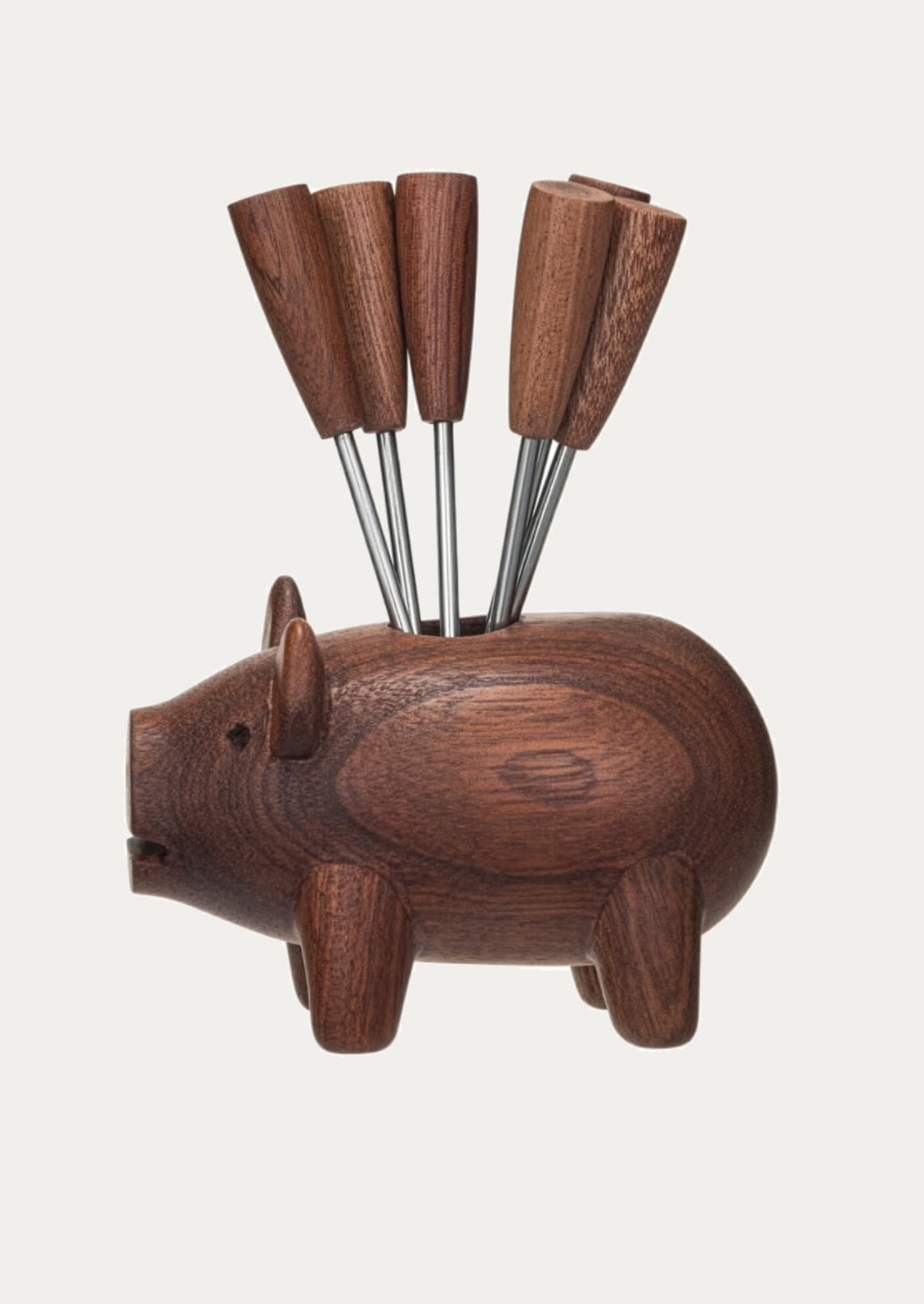 Wooden pig-shaped holder with six skewers on a white background