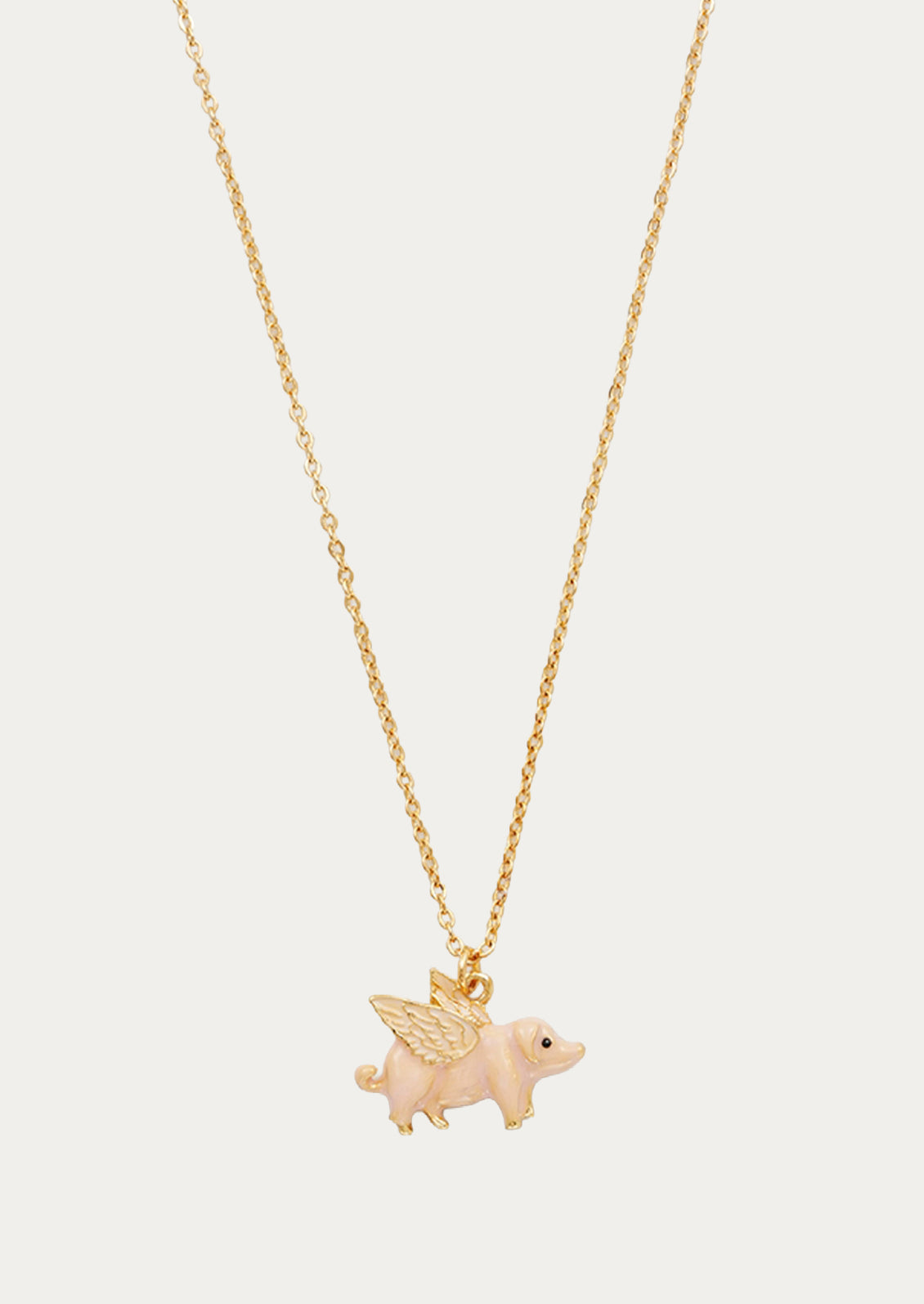 A gold plated chain necklace with a flying pig charm.