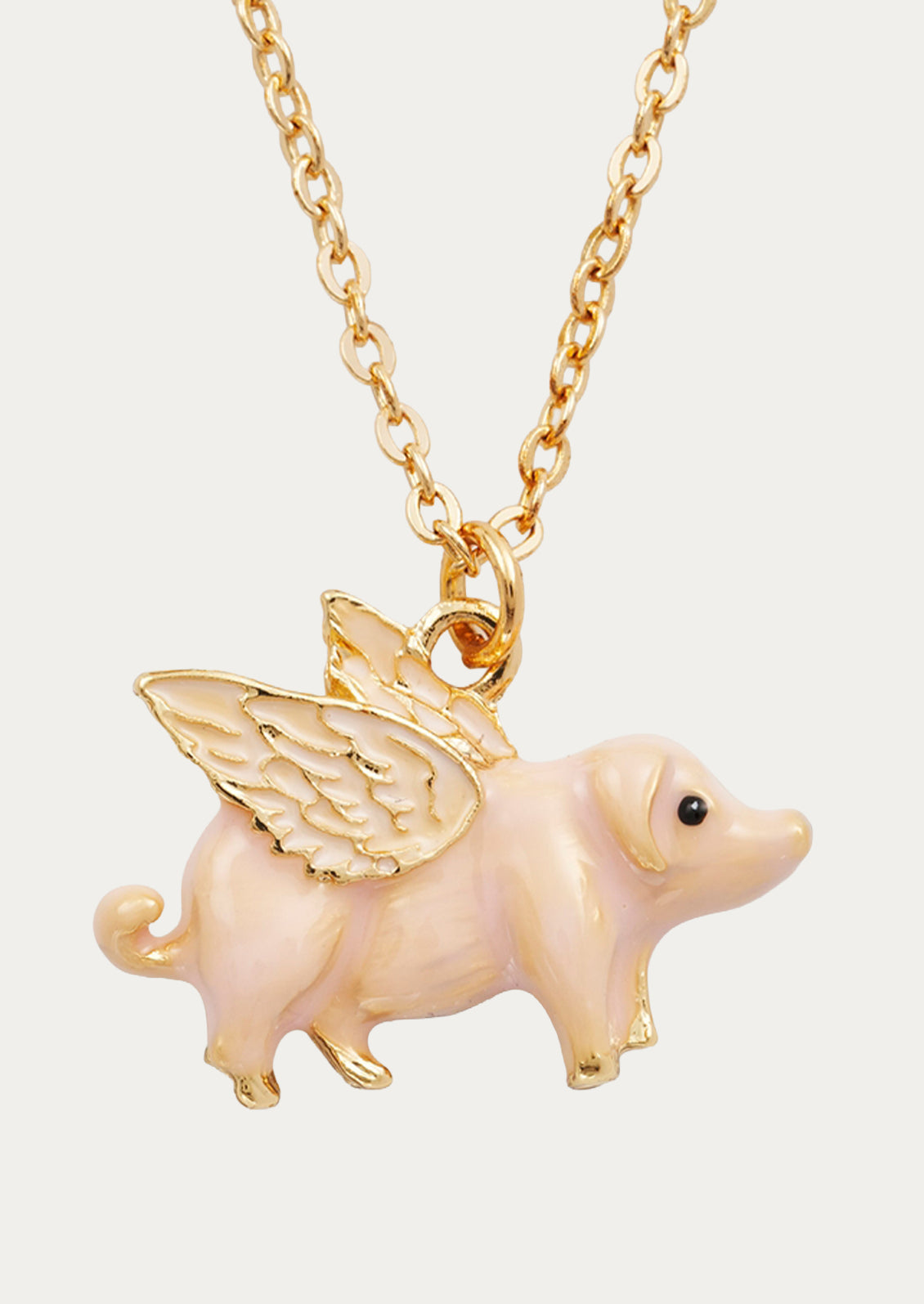 A gold plated chain necklace with a flying pig charm.