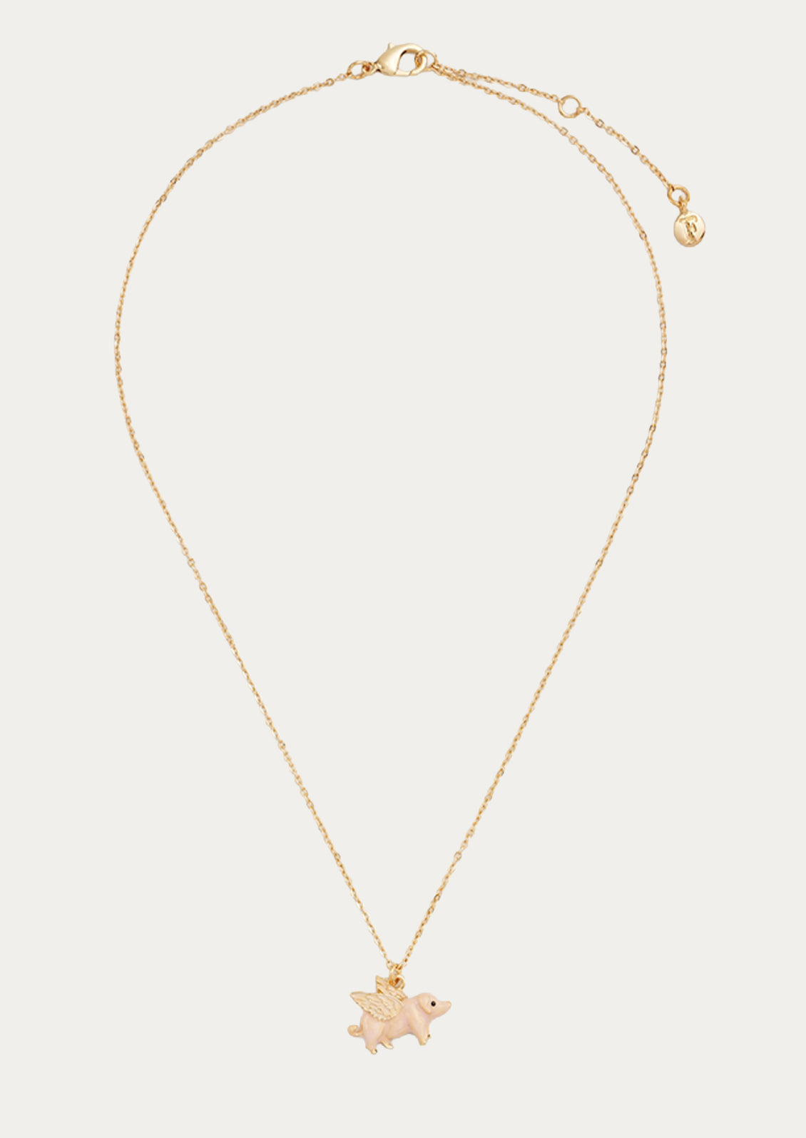 A gold plated chain necklace with a flying pig charm.