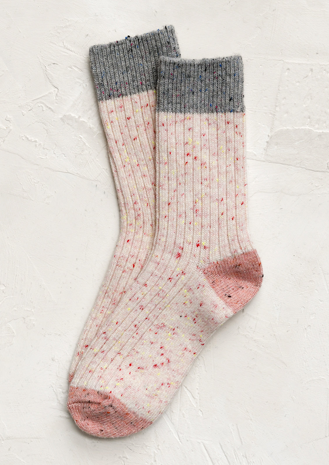 A pair of pink socks with grey contrast.