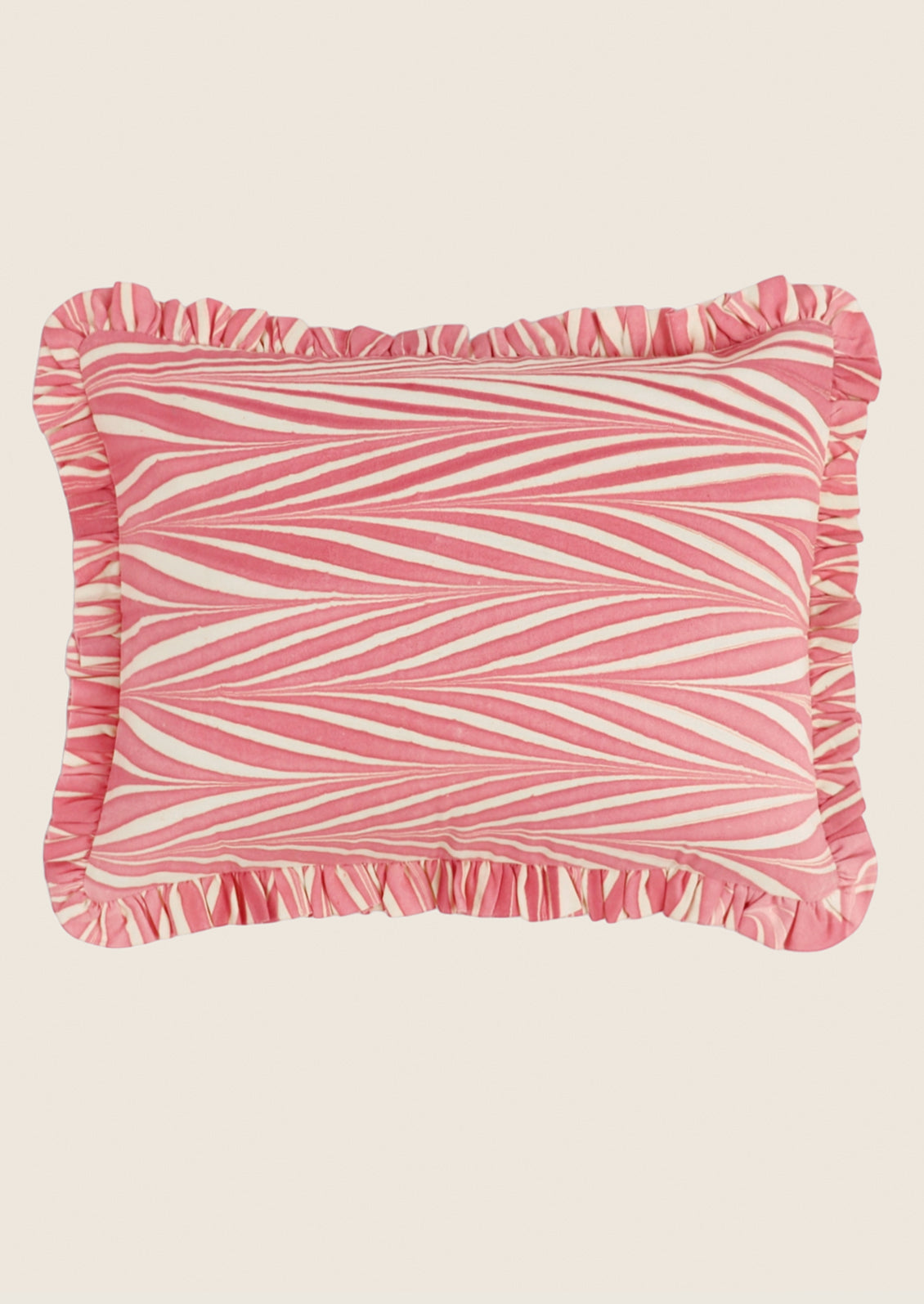 Pink and white striped pillow with ruffled edge on a beige background