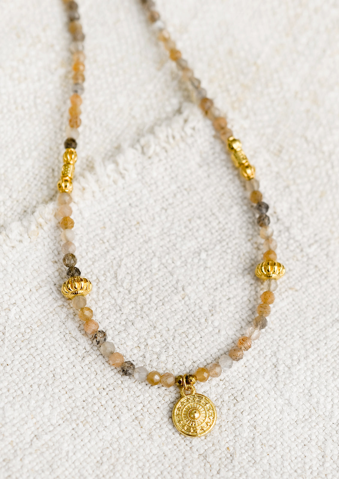 A beaded orange moonstone necklace with gold findings.
