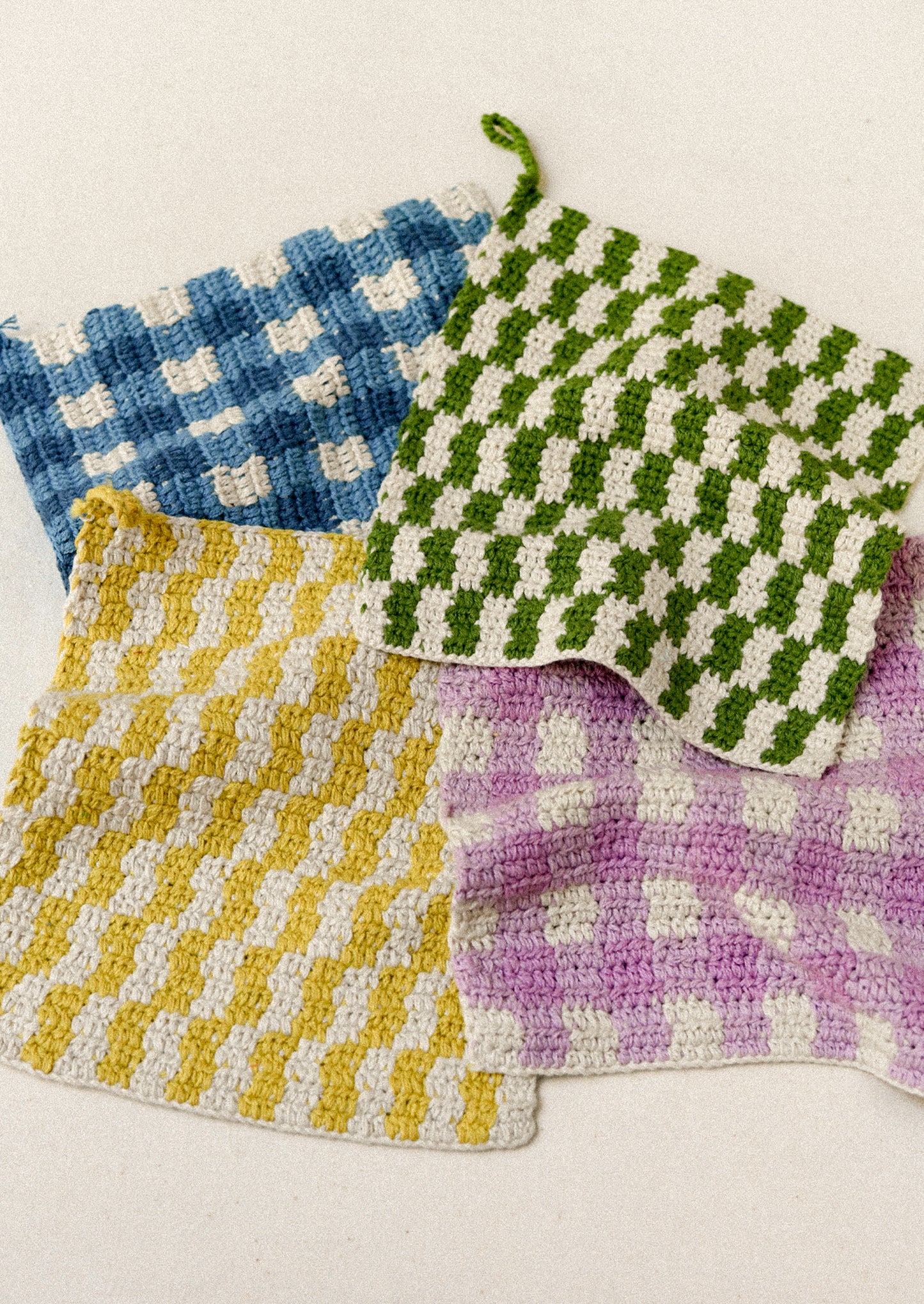 Colorful plaid crocheted potholders.