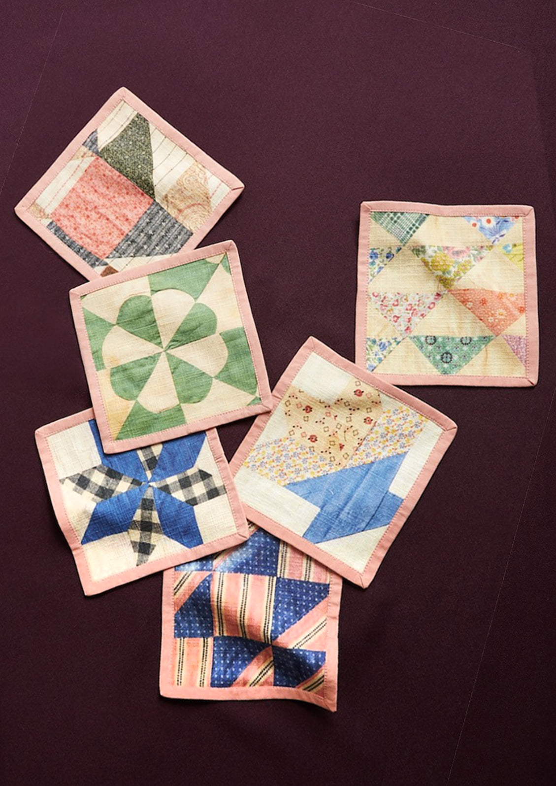 A set of quilt printed square cocktail napkins in 6 different patterns.