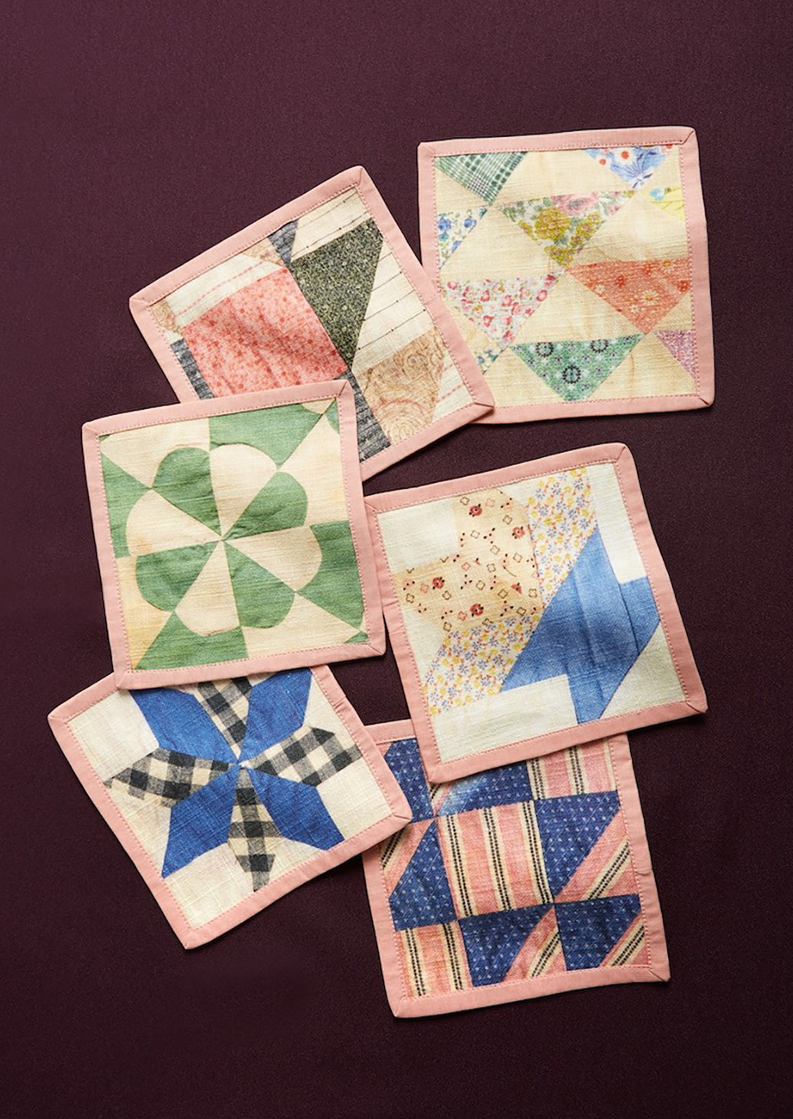 A set of quilt printed square cocktail napkins in 6 different patterns.