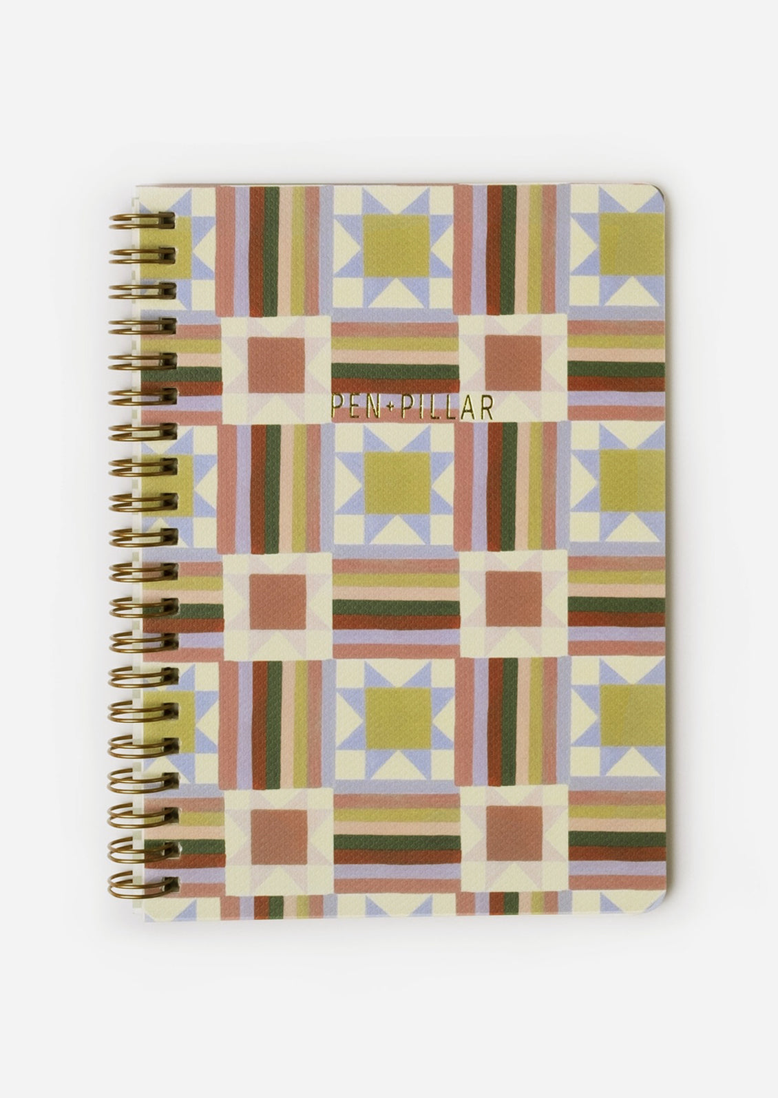 A spiral bound notebook with quilt illustrated cover.