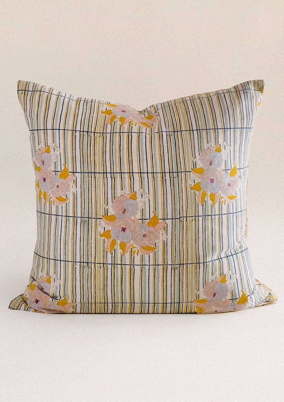 A throw pillow with stripe and floral pattern.