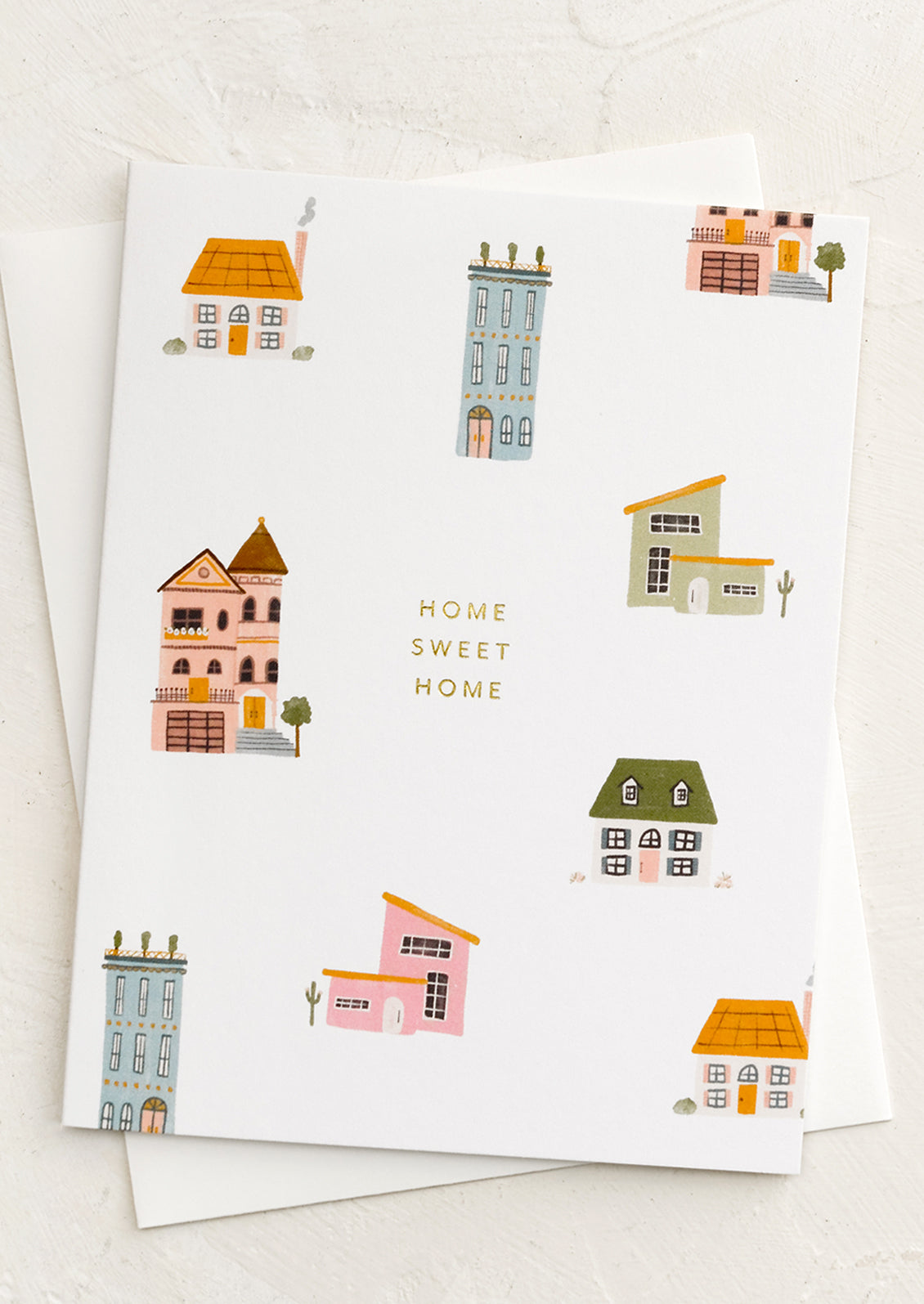 A greeting card with houses print reading "home Sweet Home".