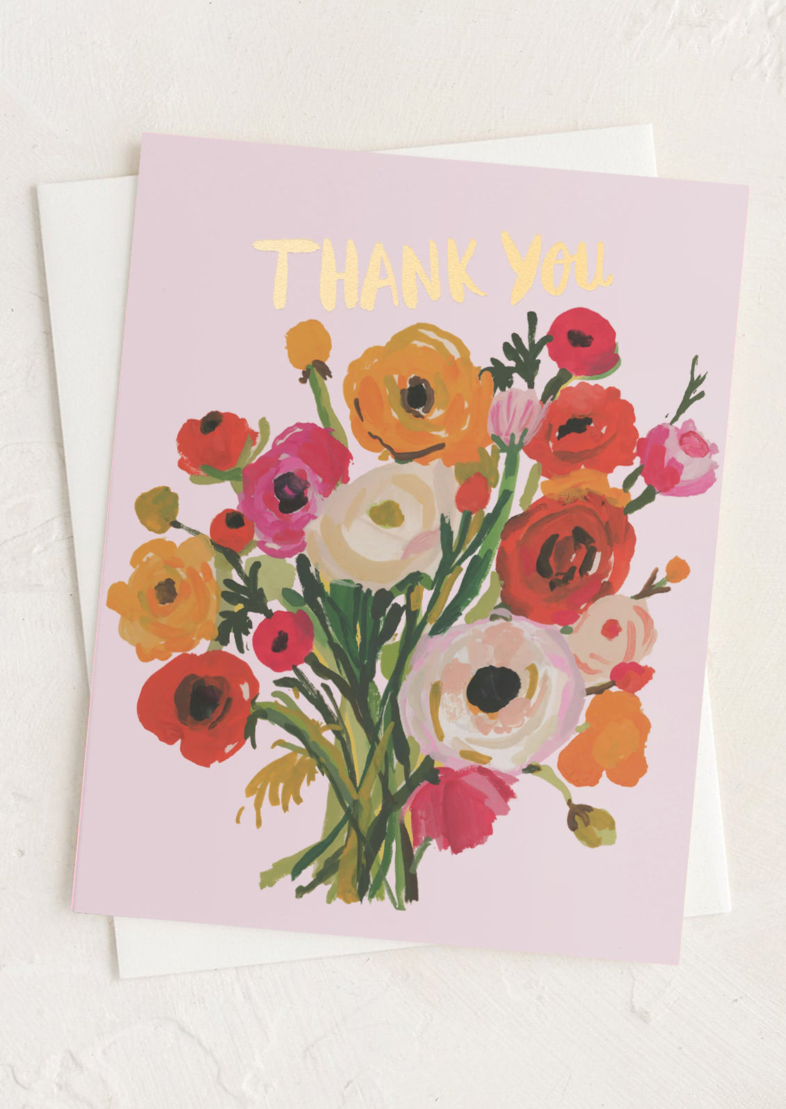 A pink thank you card with illustration of ranunculus flowers and gold 'thank you' text.