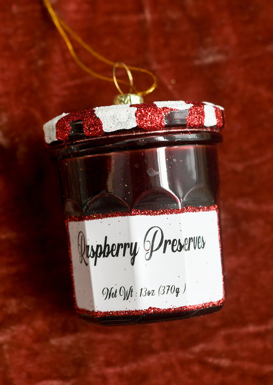 A glass ornament resembling Bonne Maman Raspberry Preserves jam jar.