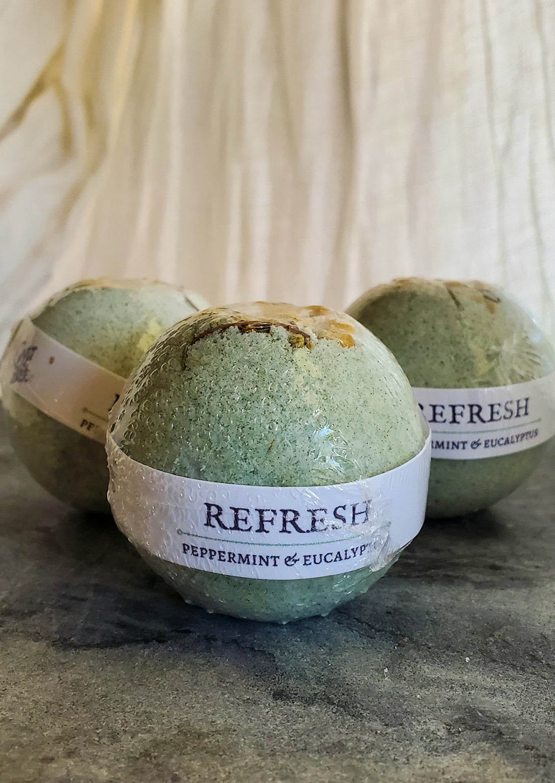 Green bath bombs in "refresh" scent.