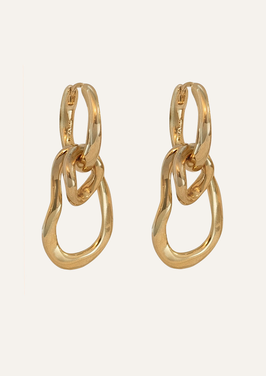 A pair of unique gold hoops earrings.