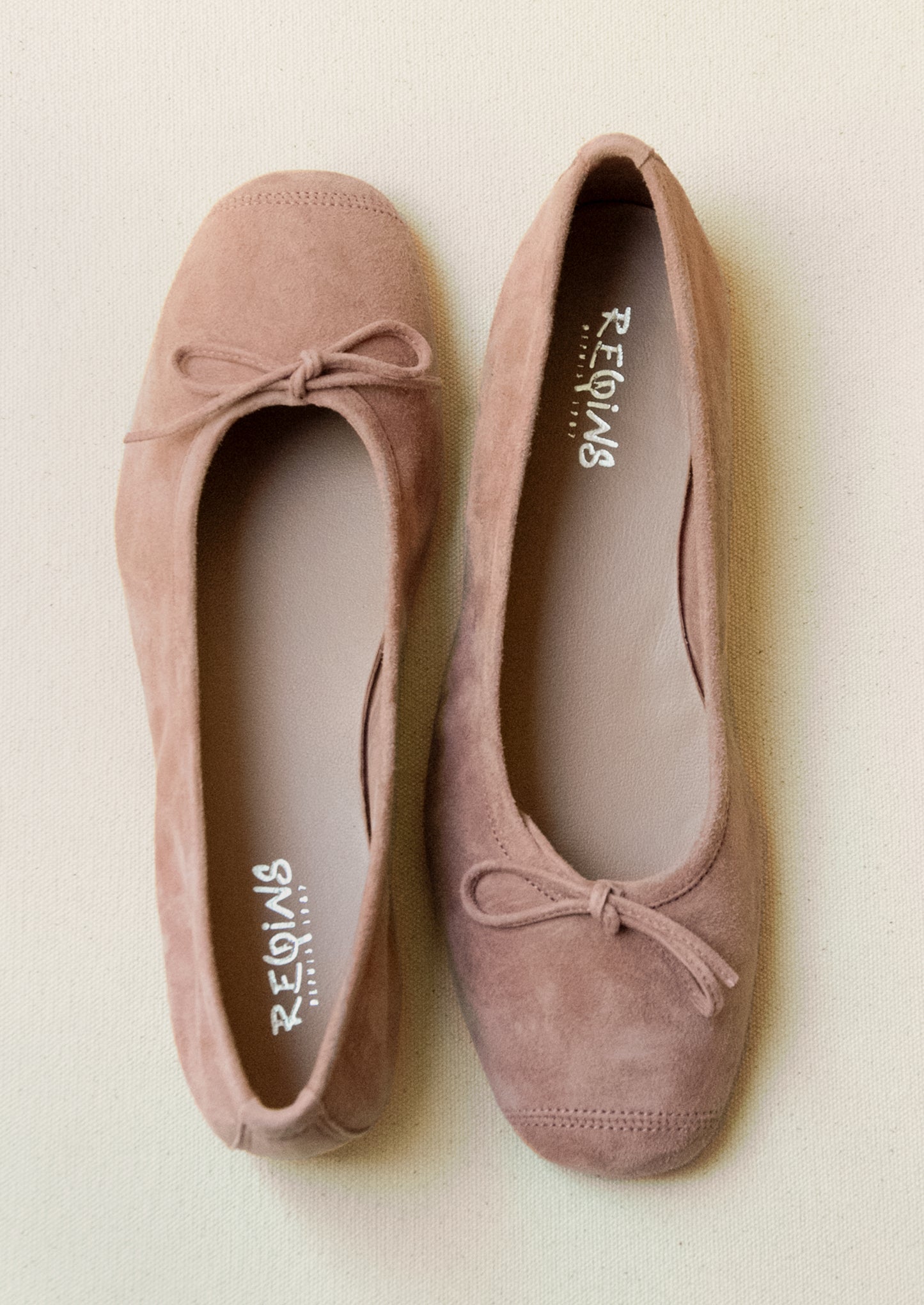 A pair of suede ballet flats in antique rose.