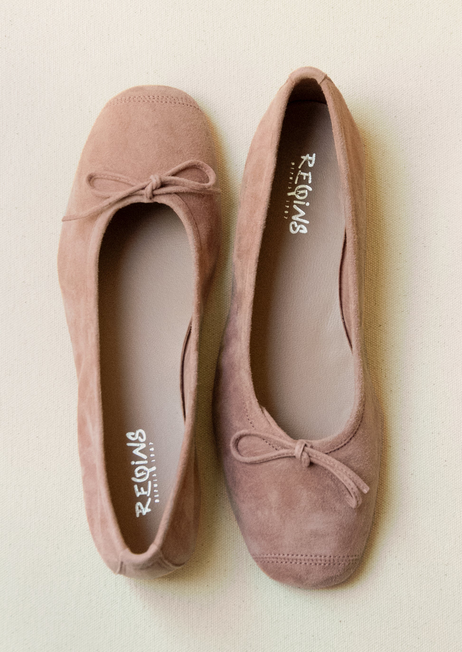 A pair of suede ballet flats in antique rose.