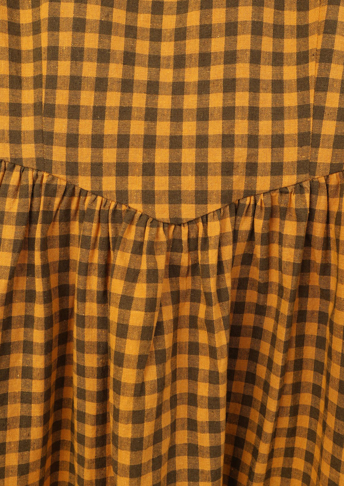 Brown and mustard gingham fabric with ruched detailing.