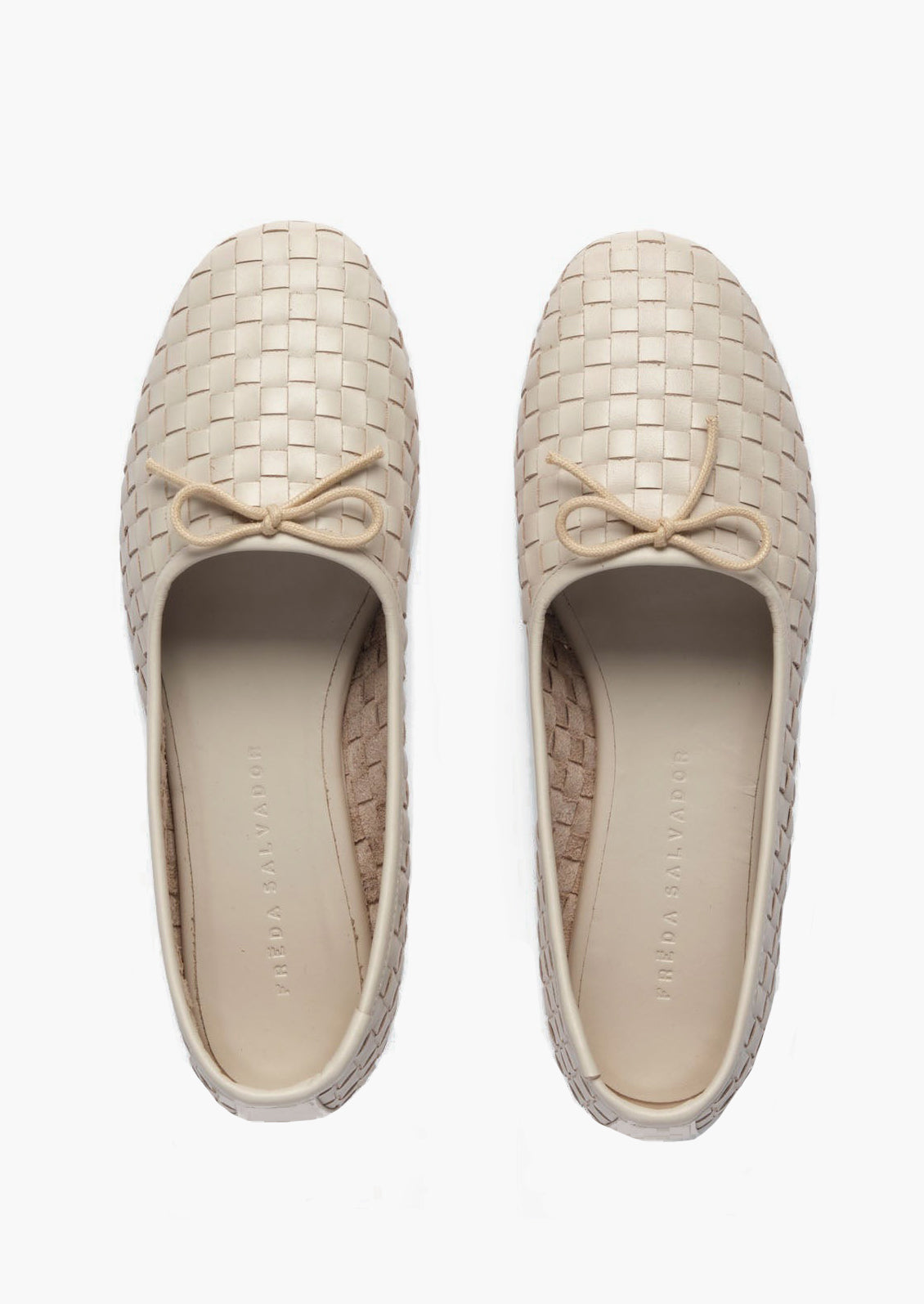 Cream woven leather ballet flats with bow detail on vamp.
