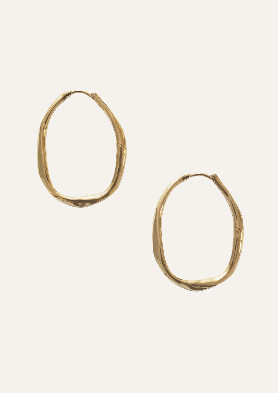 A pair of large gold hoop earrings.