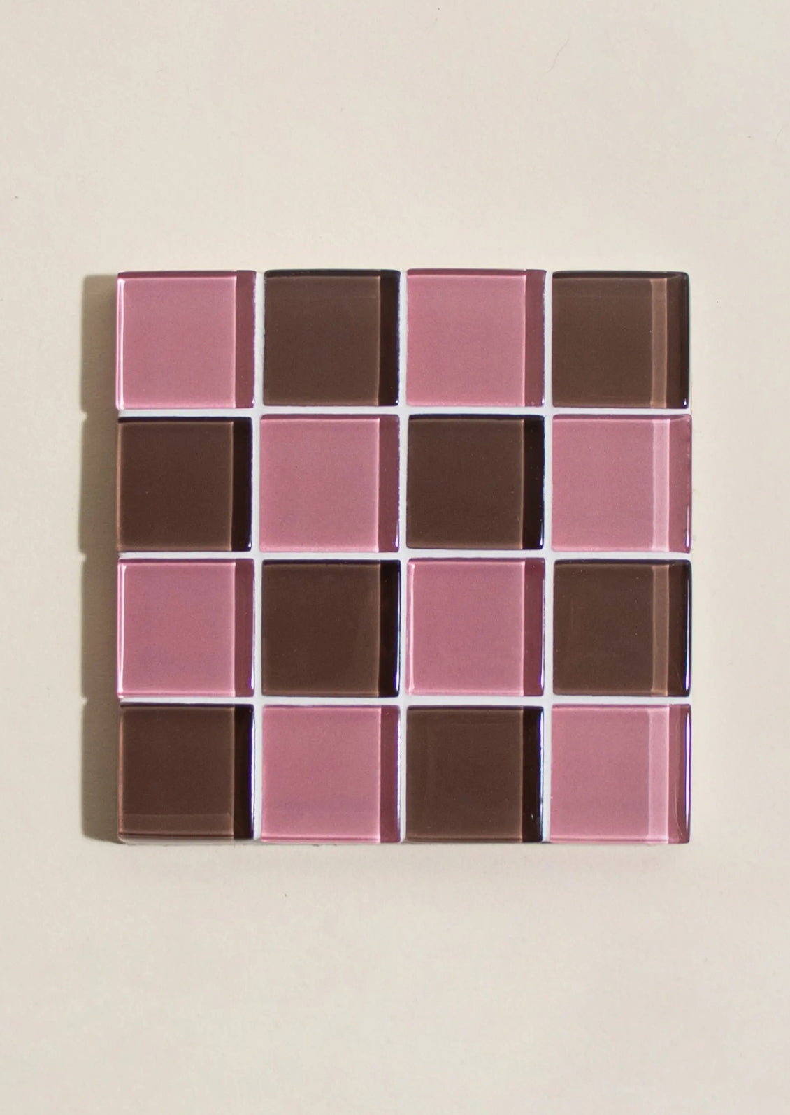 A glass tile coaster in two tone checker pattern.